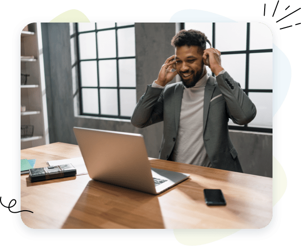 Very happy customer using headphones on his laptop